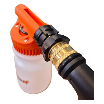 Close-up of a garden hose nozzle with an orange spray head and black and gold fitting on a white background.